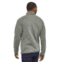 Man stood backwards wearing the Patagonia mens grey winter sweater on a white background