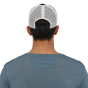 Man stood wearing the Patagonia eco-friendly duckbill trucker hat on a white background