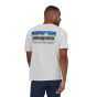 Man stood backwards wearing the eco-friendly Patagonia p6 mission logo tshirt in white on a white background