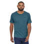 Man stood wearing the Patagonia organic cotton P-6 Mission short sleeved t-shirt in abalone blue on a white background