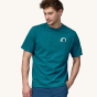 A man models the front of the Patagonia Men's Rubber Tree Mark Responsibili-Tee - Belay Blue on a plain background.