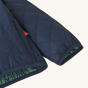 
A close up of the cuffs and arms of a navy blue Patagonia Little Kids' Nano Puff Jacket