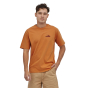 Man stood on a white background wearing the Patagonia cloudberry orange 73 skyline t-shirt 