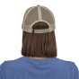 view of the back of a person wearing a Patagonia P-6 Logo LoPro Trucker Hat in a stone beige colour way 
