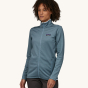 A woman models the front of the Patagonia Women's R1 Daily Jacket - Light Plume Grey / Steam Blue X-Dye against a plain background.