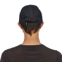 Woman facing backwards wearing the Patagonia eco-friendly P6 logo trucker hat on a white background