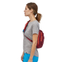 Side view of woman wearing the Patagonia Roamer red colour Atom Sling 8L bag 