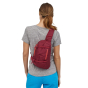 Woman wearing the Patagonia Roamer red colour Atom Sling 8L bag on their back