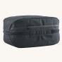 The back of the Patagonia Black Hole Medium 6L Travel Cube Organiser Bag - Smolder Blue, showing the zipper, on a cream background