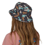 Image of the back of a person's head with long hair wearing the Patagonia Wavefarer Bucket Hat - Fly 50: Ink Black