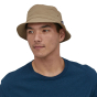 man wearing a stone coloured Patagonia Wavefarer Bucket Hat 