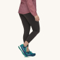 Patagonia Women's Maipo 7/8 Sports Leggings - Black. A woman models the leggings facing sideways towards the camera on a plain background.