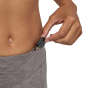 Picture of  model demonstrating the key pocket at waistband of the leggings. Picture has a white background.