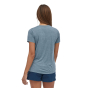Woman stood backwards on a white background wearing the Patagonia short sleeve cap cool graphic tee 