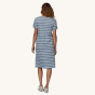 
A person wearing the Patagonia Women's Regenerative T-Shirt Dress - Sunset Stripe/Light Plume Grey showing the back of the dress 
