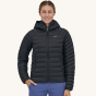 A woman models the front of the Patagonia Women's Down Sweater Hoody.
