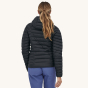 A woman models the back of the Patagonia Women's Down Sweater Hoody.