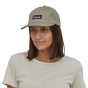 Woman wearing the Patagonia eco-friendly p-6 logo trad cap in the garden green colour on a white background