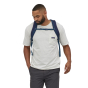 A man wearing the Patagonia Refugio Day Pack 26L - Classic Navy, stood upright, front top view, on a white background