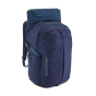Patagonia Refugio Day Pack 26L - Classic Navy, stood upright with laptop insert partly removed, on a white background