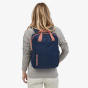 Picture of a  female model wearing the Patagonia Tamangito backpack. The picture is taken with the backpack placed on the models back. The background of the picture is white. The colour of the backpack in the picture is navy this colour is not sold on the
