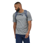 A man wearing the Patagonia Ultralight Black Hole 27L Tote Pack - Fresh Teal, front view, stood upright, white background