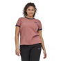 Woman stood on a white background wearing the Patagonia light star pink ringer t-shirt 