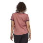Woman stood backwards wearing the eco-friendly Patagonia light star pink ringer t-shirt on a white background