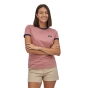 Woman stood on a white background wearing the Patagonia light star pink ringer t-shirt 