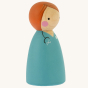 Peepul plastic-free handmade wooden female Doctor peg doll toy on an off-white background. Side view.
