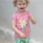 a child wearing pink organic cotton t-shirt with the white daffodil applique from piccalilly