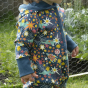 Close up of child wearing the Piccalilly organic cotton hooded playsuit in the blue galaxy print