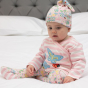 a child wearing soft pink organic cotton 3-piece baby set with the little lamb print  from piccalilly