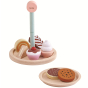 The PlanToys Bakery Stand Set, one tier of cakes and biscuits play food and the second tier used as a plate. White background.