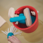 Plan Toys Cleaning Role Play Set including wooden squeegee, and cleaning spray in a red bucket. Child holding the mop.
