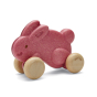 Plan Toys eco-friendly wooden push along bunny toy in pink on a white background