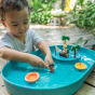 Child playing with the Plan Toys Water Play Set - an exciting play tray inspiring creative water play and is a fabulous sensory toy for toddlers. 