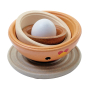 PlanToys chicken nesting Waldorf bowls upside down on a white background with a toy egg inside
