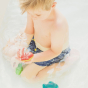 Child playing with the PlanToys Shell Bath Toy in the bath