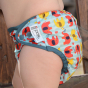 Close up of baby wearing the Close Babipur elephant reusable popper nappy
