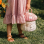 Picture of a child holding the Olli Ella Mushroom Rattan basket.