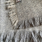 Close up of the tassels on the Respiin woollen throw blanket in the grey colour