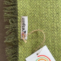 Close up of the label on the Respiin recycled wool throw blanket
