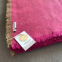 Close up of the recycled wool label on the Respiin purple throw blanket