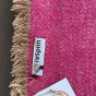 Close up of the Respiin label on the large purple woollen throw