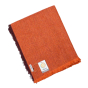 Respiin recycled wool throw blanket in the rust orange colour folded on a white background