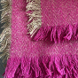 Close up of the tassels on the Respiin recycled woollen throw in the purple colour