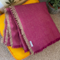 Respiin large purple throw folded in a square on a yellow cushion
