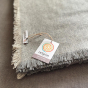 Close up of the Respiin recycled wool label on the large grey throw blanket