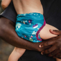 person holding baby wearing nappy
